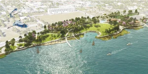 A birdseye rendering of a waterfront park featuring lush green lawns, walking paths, a tidal amphitheater, and sailboats on the water.